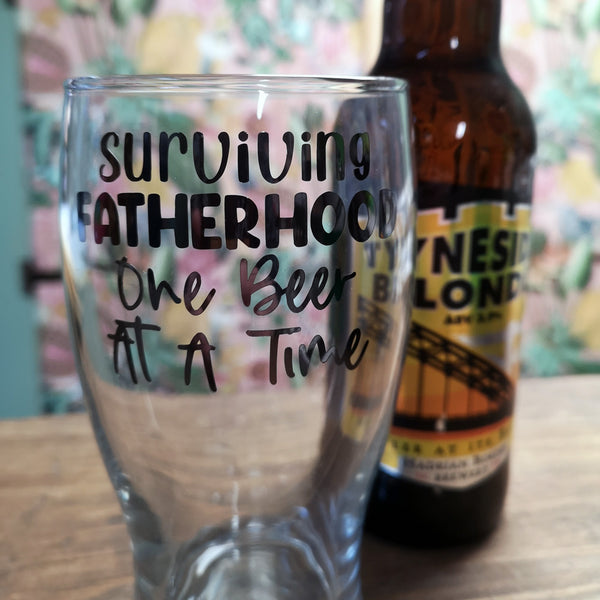 'Surviving Fatherhood, One Beer at a Time' Pint Glass